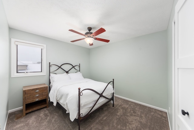 bedroom featuring dark carpet, a textured ceiling, and ceiling fan