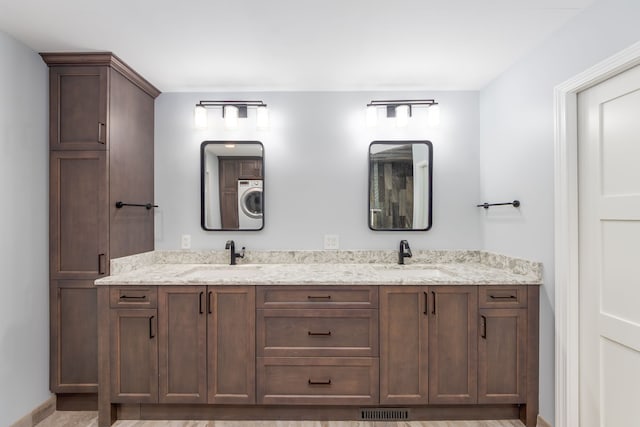 bathroom with vanity and washer / clothes dryer