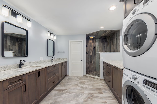 interior space featuring tiled shower, stacked washer / drying machine, and vanity