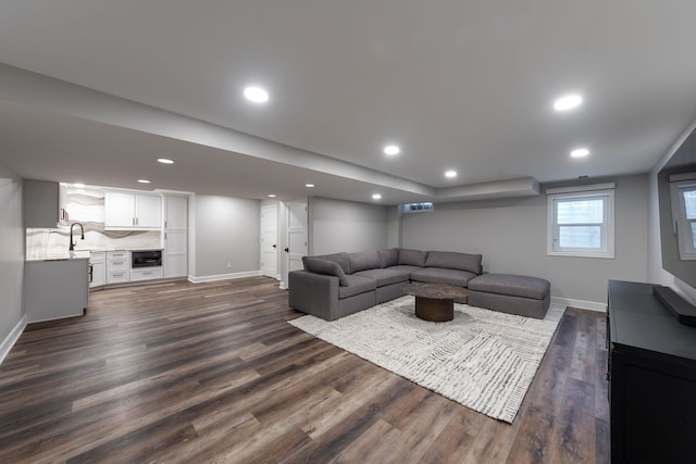 living room with dark hardwood / wood-style flooring and sink