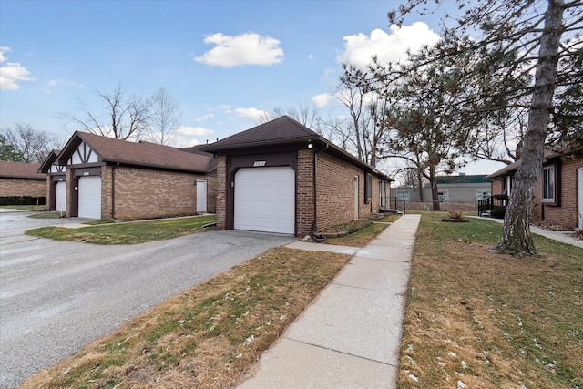 view of side of home with a garage and a lawn