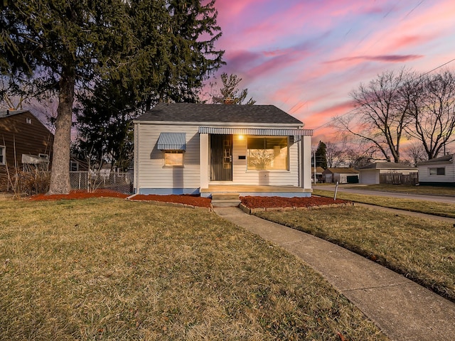 bungalow-style house featuring a lawn