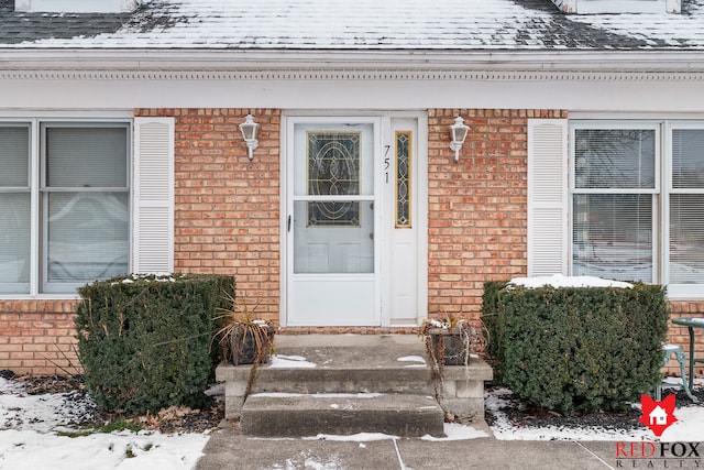 view of snow covered property entrance