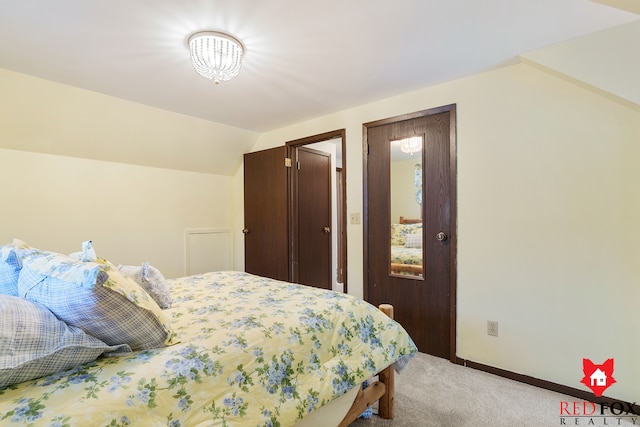 bedroom with light carpet and vaulted ceiling