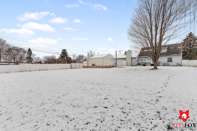 view of yard layered in snow