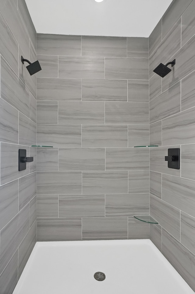 bathroom with a tile shower