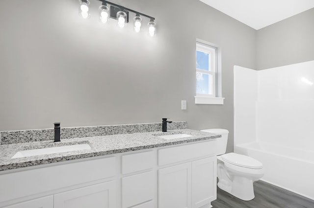 bathroom with vanity, toilet, and hardwood / wood-style floors