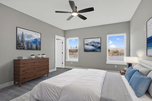 bedroom with ceiling fan and dark carpet