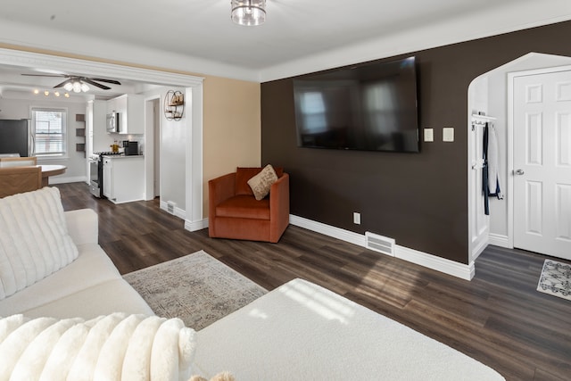 living room featuring ceiling fan and dark hardwood / wood-style flooring