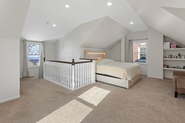 bedroom with lofted ceiling, light carpet, and multiple windows