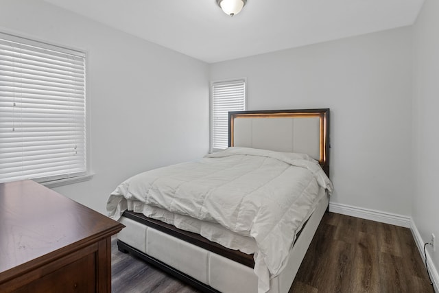 bedroom with dark hardwood / wood-style flooring