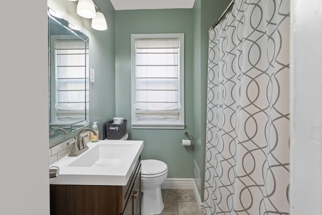 bathroom featuring tile patterned flooring, vanity, and toilet