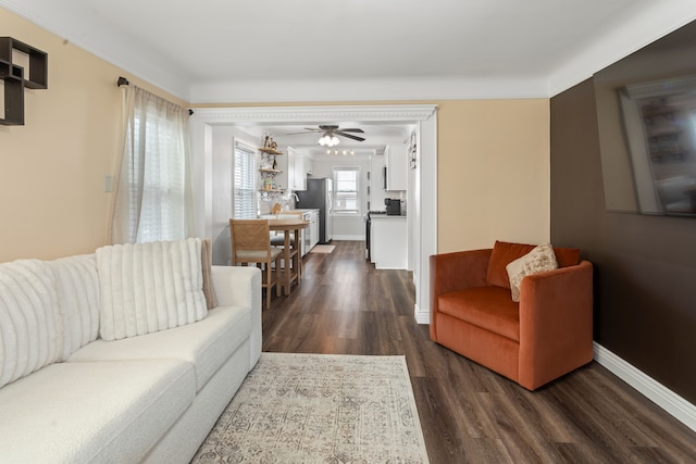 living room featuring dark hardwood / wood-style floors and ceiling fan