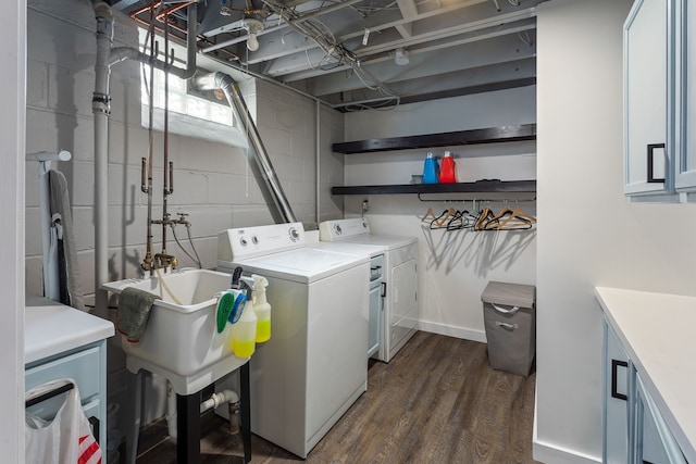 clothes washing area featuring dark wood-type flooring and washer and clothes dryer