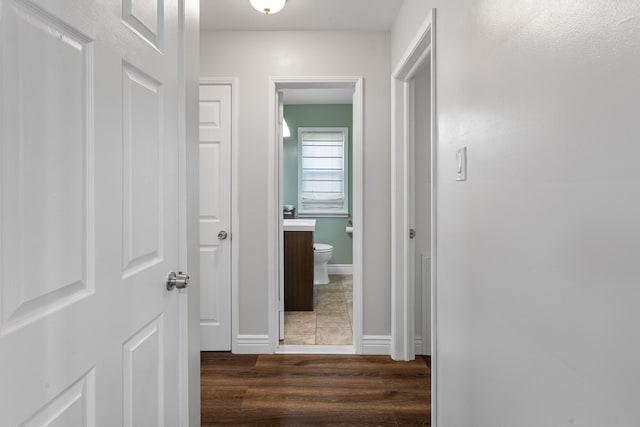 hallway with dark hardwood / wood-style flooring