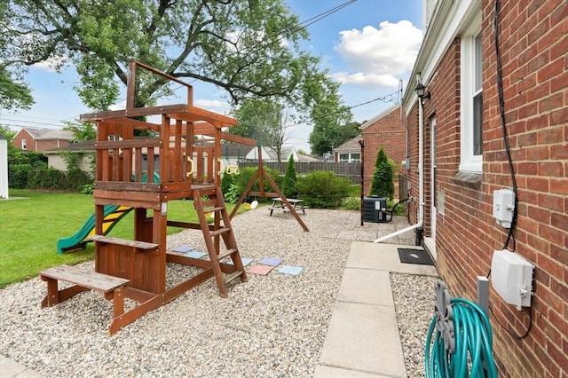 view of playground featuring central AC unit and a lawn