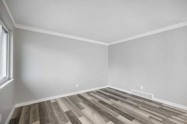 unfurnished room with hardwood / wood-style floors and ornamental molding