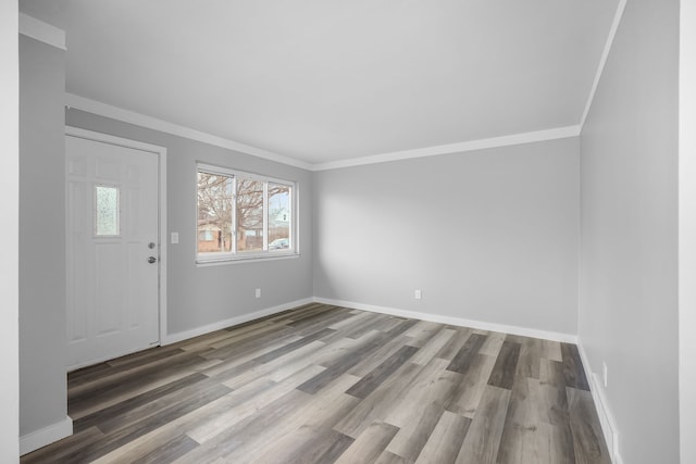 foyer entrance with hardwood / wood-style floors and crown molding