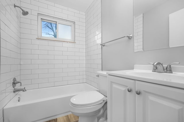 full bathroom with vanity, wood-type flooring, tiled shower / bath combo, and toilet