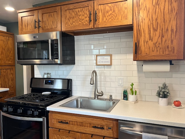 kitchen featuring backsplash, stainless steel appliances, and sink