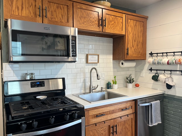 kitchen with sink, appliances with stainless steel finishes, and tasteful backsplash