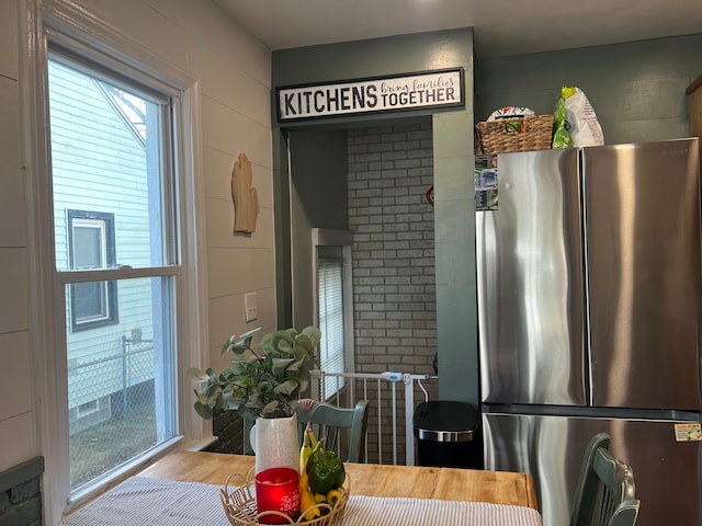 kitchen with stainless steel fridge and light hardwood / wood-style flooring