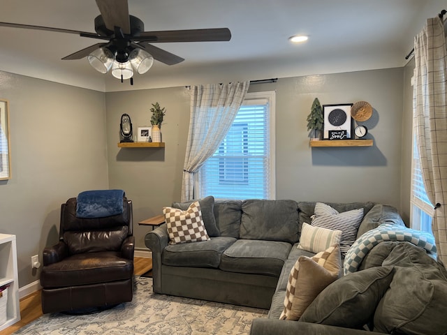 living room featuring light hardwood / wood-style flooring and ceiling fan