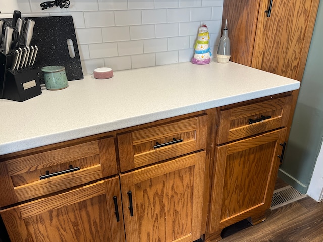 interior details with dark hardwood / wood-style flooring and tasteful backsplash