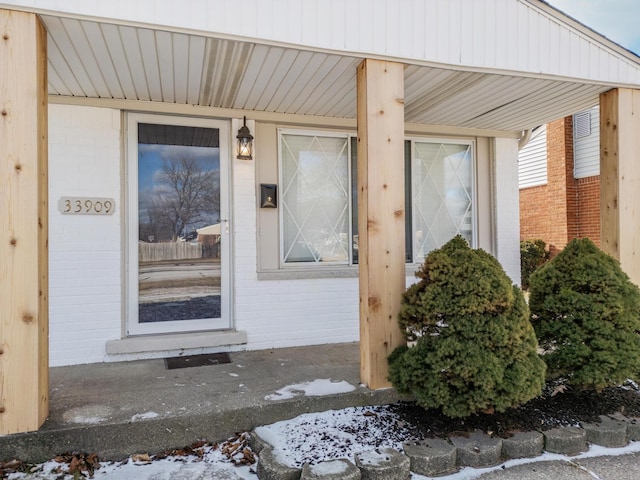 view of snow covered property entrance