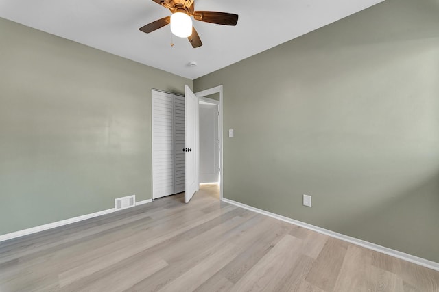 empty room featuring ceiling fan and light wood-type flooring