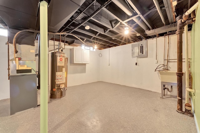 basement featuring electric panel and water heater