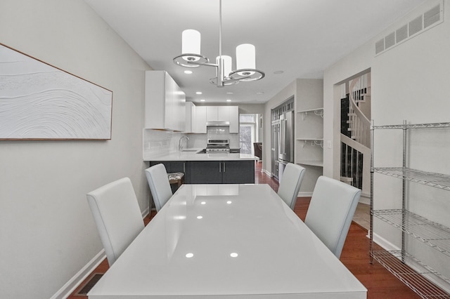 dining space with dark hardwood / wood-style floors and sink