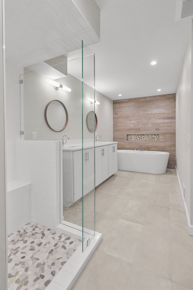 bathroom featuring vanity and shower with separate bathtub