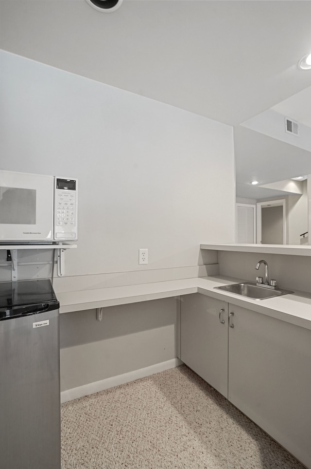 kitchen featuring gray cabinets and sink