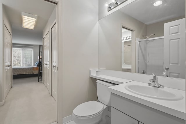 bathroom with a shower, vanity, and toilet