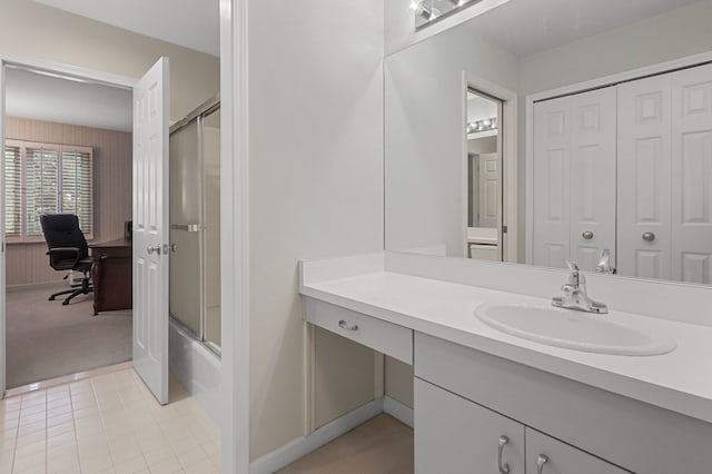 bathroom with tile patterned floors, vanity, and combined bath / shower with glass door