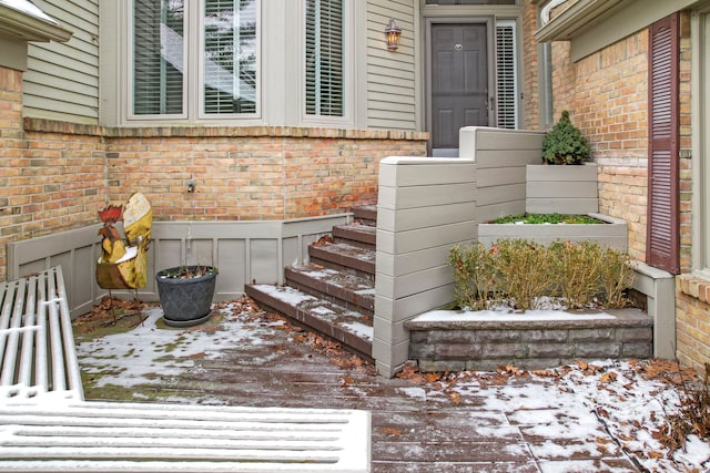 view of snow covered property entrance