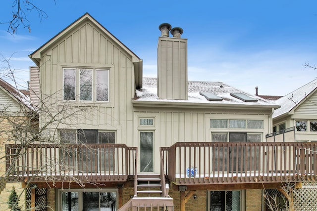 rear view of house featuring a balcony and a deck