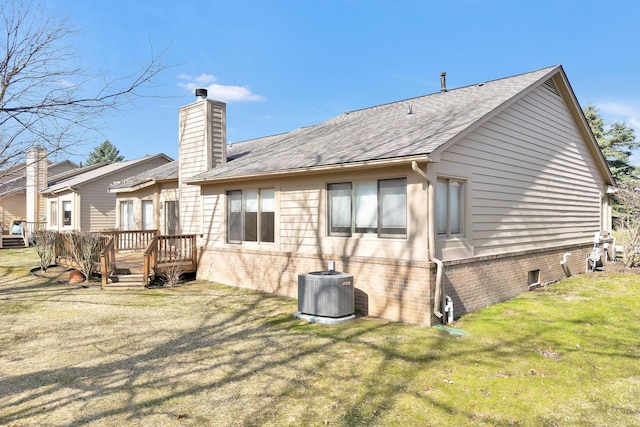 5059 Pheasant Cv, West Bloomfield, MI 48323 - back of house featuring roof with shingles, a deck, a chimney, a lawn, and central AC unit