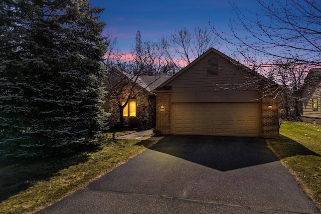 5059 Pheasant Cv, West Bloomfield, MI 48323 - view of front of house featuring an attached garage, brick siding, a front yard, and aphalt driveway