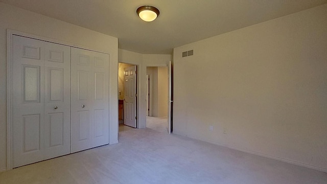 5059 Pheasant Cv, West Bloomfield, MI 48323 - unfurnished bedroom featuring a closet, light carpet, baseboards, and visible vents