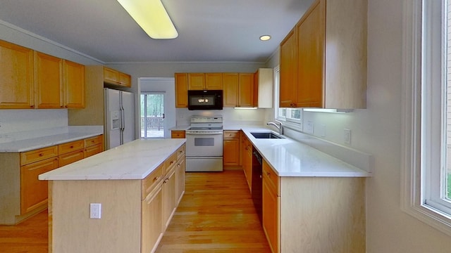 5059 Pheasant Cv, West Bloomfield, MI 48323 - kitchen featuring white appliances, a center island, light wood-style flooring, and a sink