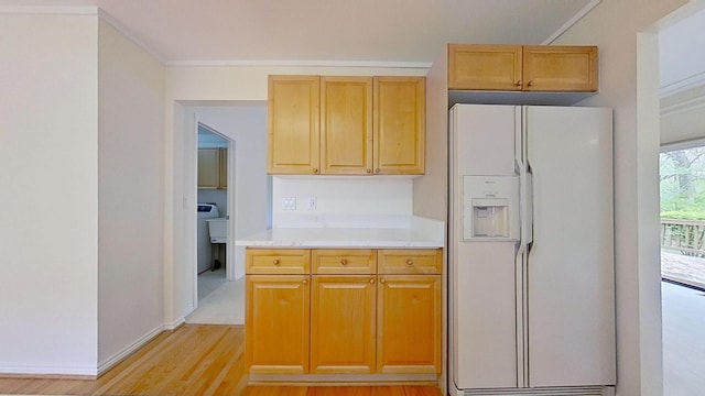 5059 Pheasant Cv, West Bloomfield, MI 48323 - kitchen featuring ornamental molding, white fridge with ice dispenser, light wood-style flooring, light countertops, and baseboards