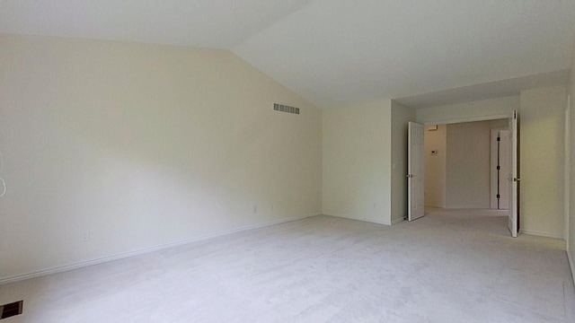5059 Pheasant Cv, West Bloomfield, MI 48323 - spare room with baseboards, light carpet, visible vents, and vaulted ceiling