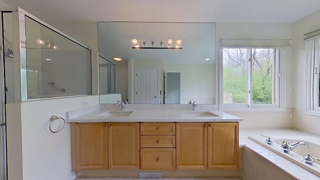 5059 Pheasant Cv, West Bloomfield, MI 48323 - bathroom with double vanity, a garden tub, a shower stall, and a sink