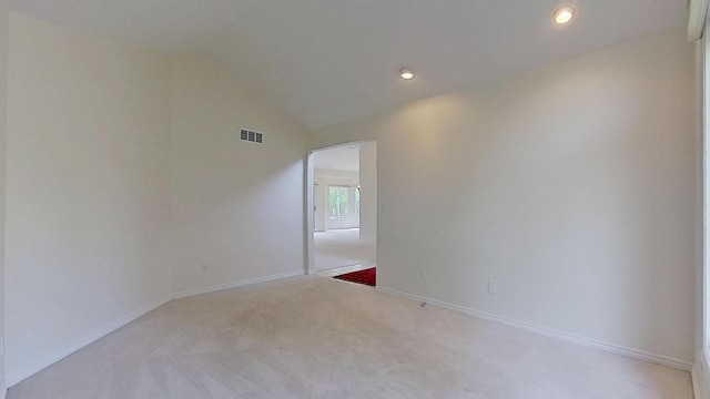 5059 Pheasant Cv, West Bloomfield, MI 48323 - empty room featuring visible vents, baseboards, lofted ceiling, and carpet floors