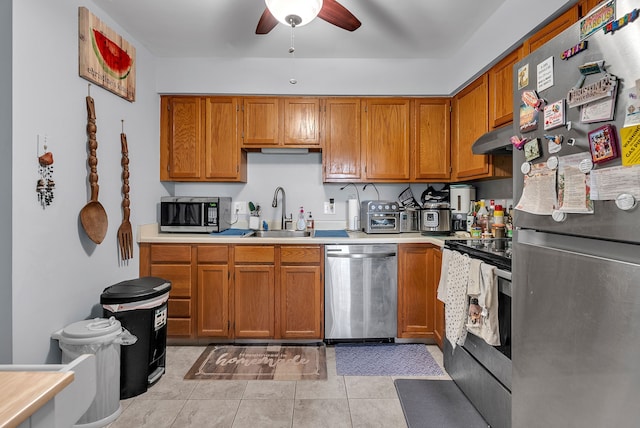 kitchen with light tile patterned flooring, stainless steel appliances, ceiling fan, and sink