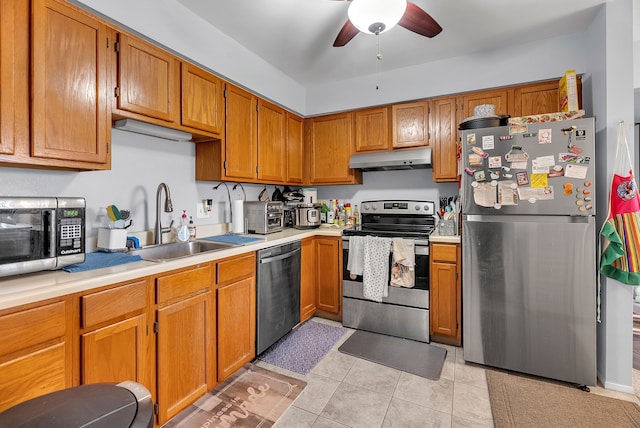 kitchen with ceiling fan, sink, light tile patterned floors, and stainless steel appliances