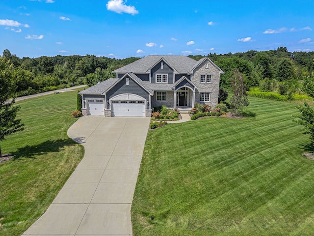 craftsman-style home featuring a garage and a front yard