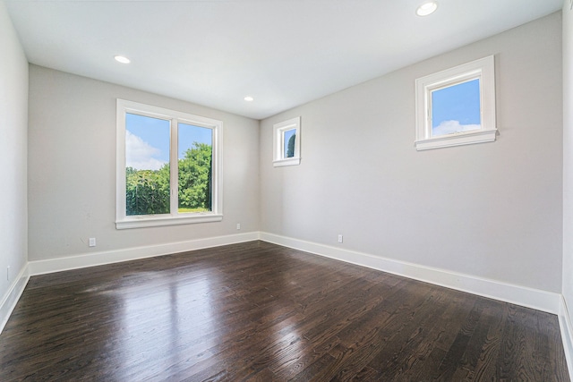 empty room with dark hardwood / wood-style flooring